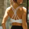 51p0-bCKdiL.jpg Strappy Sports Bra for Women Sexy Crisscross Back Light Support Yoga Bra with Removable Cups